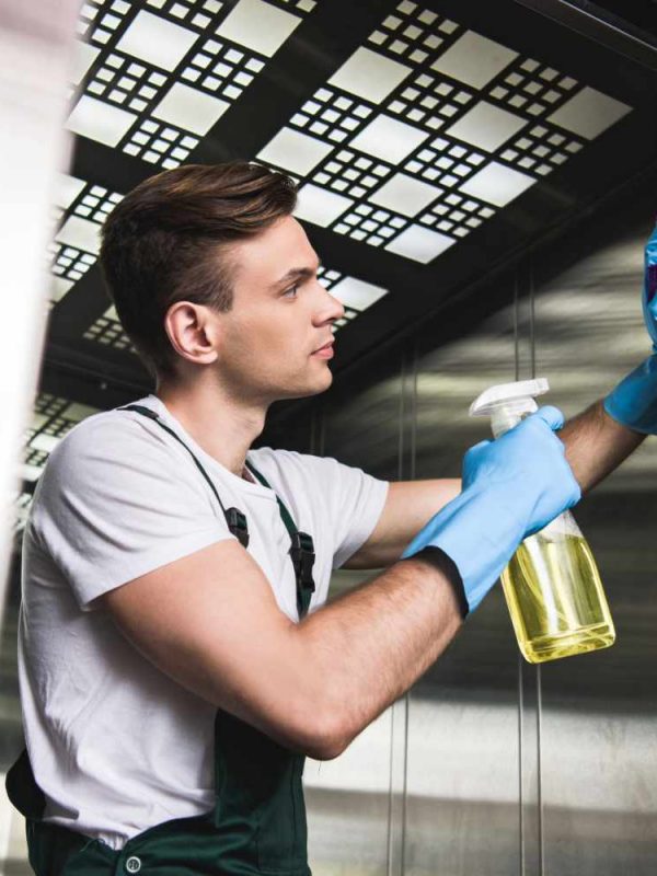low-angle-view-of-handsome-young-cleaner-washing-e-62YXDNM_2.jpg