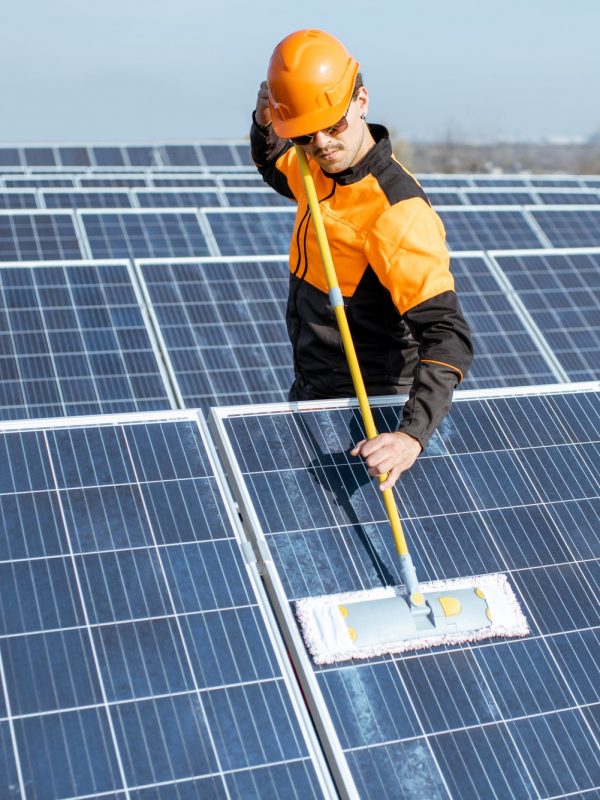 Workman cleaning solar panels
